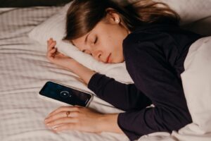 Pretty Woman Sleeping Beside Her Cellphone