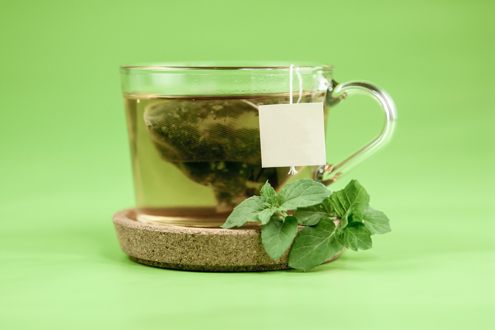 clear glass mug with green leaves