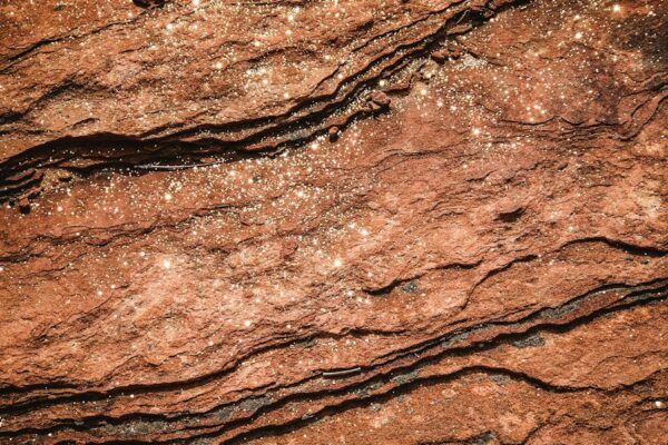 a close up of a rock surface with water
